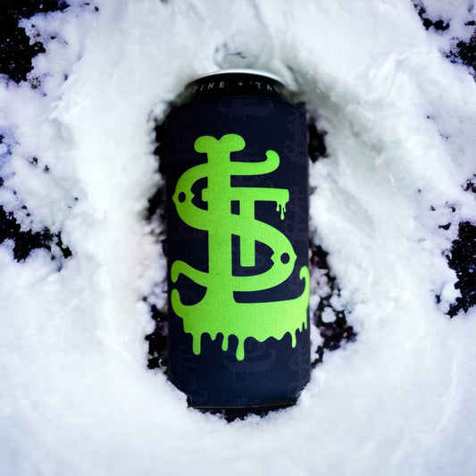 A black beverage can with a bright neon green dripping dollar-sign style logo, partially surrounded by snow on a dark surface.